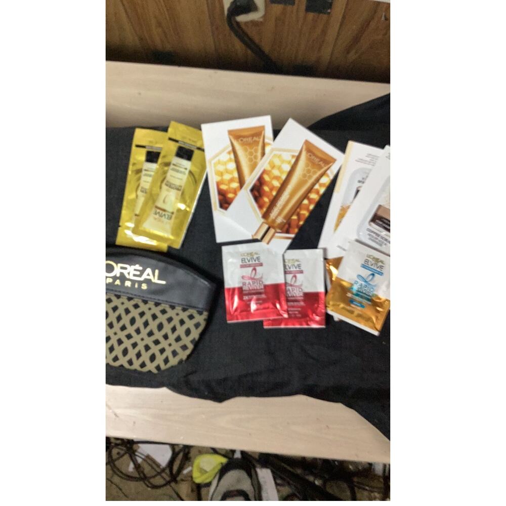 L'Oréal Small Gold And Black Makeup Bag with a sample assortment